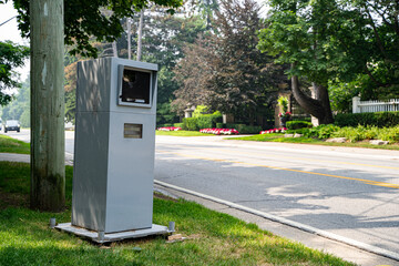 View of automatic speed radar device box on roadside.