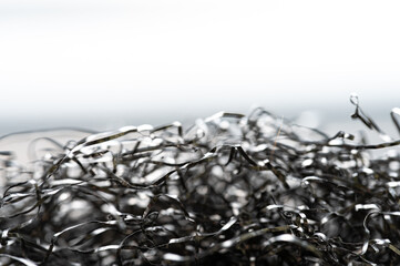 close-up view of shimmering black metallic shavings arranged in an artistic manner atop a smooth...