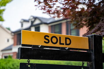 View of sold sign in front of house.