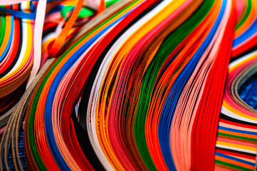 A vibrant close-up of multi coloured strips in flowing, waves. Perfect for abstract backgrounds,...