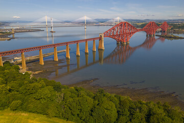 Aerial image featuring the Forth bridge with the Forth Road Bridge and Queensferry crossing Bridge...