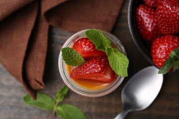 Tasty panna cotta with caramel, strawberries and mint on table, flat lay