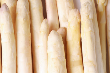 Raw white asparagus spears as background, closeup