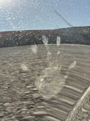 imprint of a child's palm on the mirror surface of a car