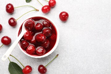 Tasty cherry jam and fresh fruits on light table, flat lay. Space for text
