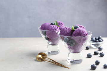 Tasty sorbet with blueberries and mint on light grey table, closeup. Space for text