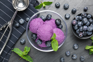 Tasty sorbet with blueberries and mint on black table, flat lay