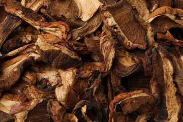 Pieces of dried mushrooms as background, top view