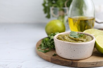 Tasty sauce with cilantro and other ingredients on white table, closeup. Space for text