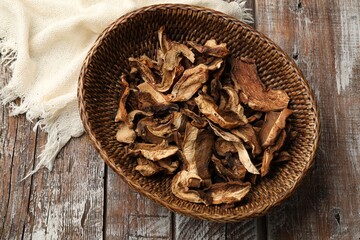 Dried chanterelle mushrooms on wooden table, top view