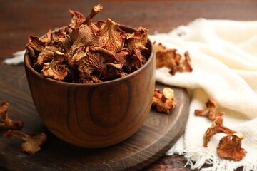 Dried chanterelle mushrooms on wooden table, closeup