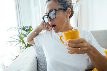 Beautiful adult woman relaxing at home after a stressful day – Real-life moment of fatigue,...