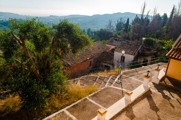Rustic Village with Terracotta Roofs and Scenic Hills