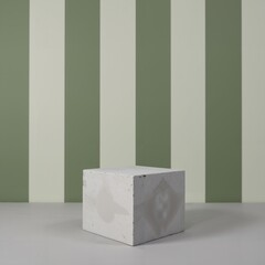 Product presentation template. A concrete block sitting in front of a green and white striped wall.