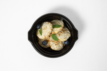 Apple cookies with shredded coconut on a plate against a white background