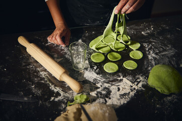 Chef Preparing Homemade Spinach Dough Dumplings in Rustic Setting