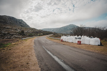 Photograph of a road under repair, cloudy day.