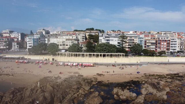 PRAIA DO MOLHE, PORTO, PORTUGAL - AUGUST 23TH, 2022: Drone footage of this beautiful beach in the north of Portugal. Golden sand, long breakwater, and stunning sunsets along the Atlantic coast.