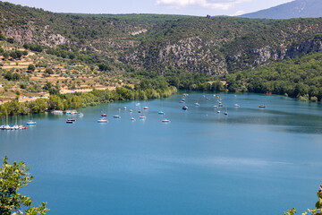 View of the turquoise lake of Sainte-Croix near Bauduen a medieval village on the water’s edge. The Alpes-de-Haute-Provence , France.