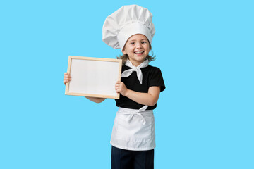 full length adorable kid holding menu while playing chef wanting become professional cook enfant adorable tenant un menu tout en jouant au chef cuisinier qui veut devenir cuisinier professionnel