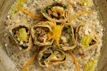 Gourmet vegetarian Mediterranean rolls served on a creamy quinoa or risotto, a healthy and modern...