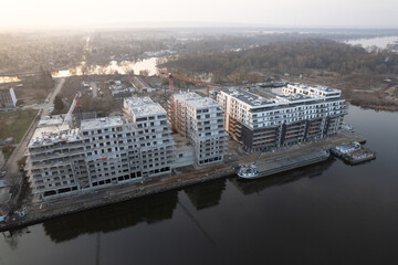 Aerial view of a large residential construction site on a riverbank