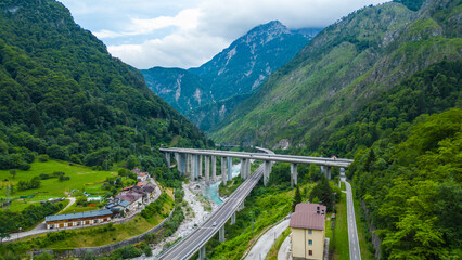 Scenic aerial view of Ciclovia Alpe Adria through Pietratagliata and gorge, Italy – bridges, turquoise river, mountain village, toll road