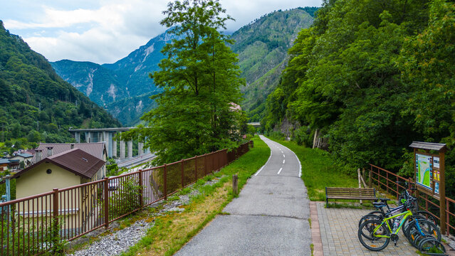 Scenic aerial view of Ciclovia Alpe Adria through Pietratagliata and gorge, Italy – bridges, turquoise river, mountain village, toll road
