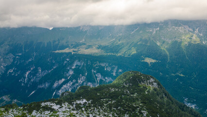 Dramatic aerial view of Sella Nevea in summer under stormy clouds – rugged cliffs and deep...