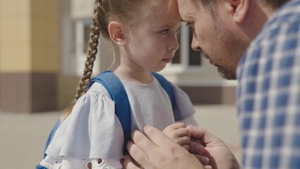 close-up face of little upset child, divorce single father family, student daughter problem with school backpack, disappointment stress kid emotion, child education time, paren psychology of sadness.