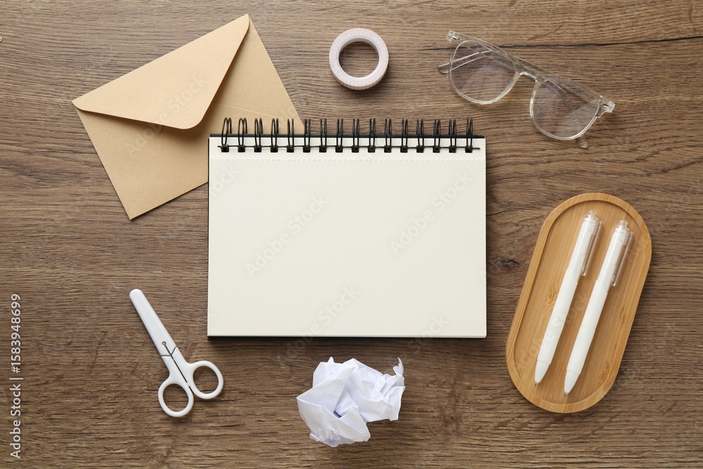 Poster flat lay composition with notebook on wooden table