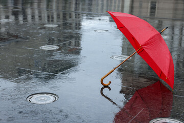 Red umbrella under heavy rain outdoors, space for text