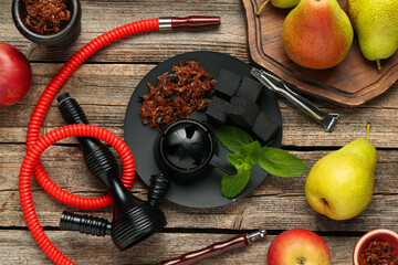 Hookah, coal and fresh fruits on wooden table, flat lay