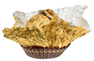 Empty golden foil wrapper from round candy, partially unfolded and placed in brown paper form, isolated on background.