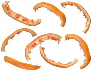 Several curved strips of grapefruit peel with pink pulp remaining, arranged on an isolated background