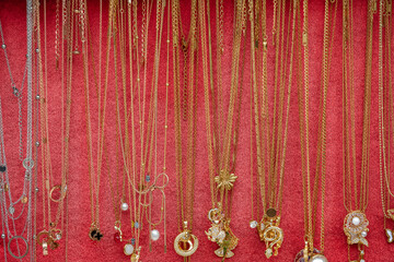 Gold jewelry on red background. Texture. Gold jewelry diamond rings in box.
