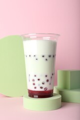 Tasty refreshing bubble tea on pink background