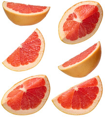 Several sliced red grapefruit wedges showing pink flesh and yellow rind, arranged on isolated background.