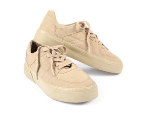 Pair of stylish beige sneakers on white background