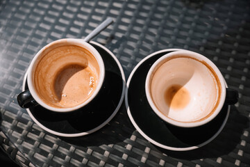 Enjoying coffee at a cozy cafe table in the morning light
