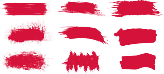 Vivid red brush strokes created with textured paint on a blank canvas showcasing artistic expression and creativity in a studio setting.