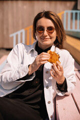 Enjoying a sunny afternoon with a delicious sandwich on vibrant steps