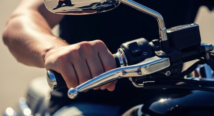 Close-up of a hand gripping the handlebar and brake lever of a motorcycle.