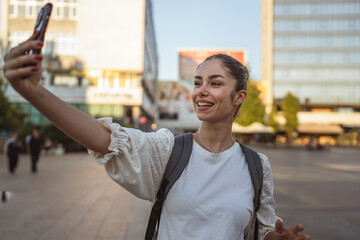 woman shows the environment with friends on a video call on cellphone