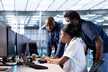 Teamworking technicians reconfiguring server farm to optimize it for data processing requirements...