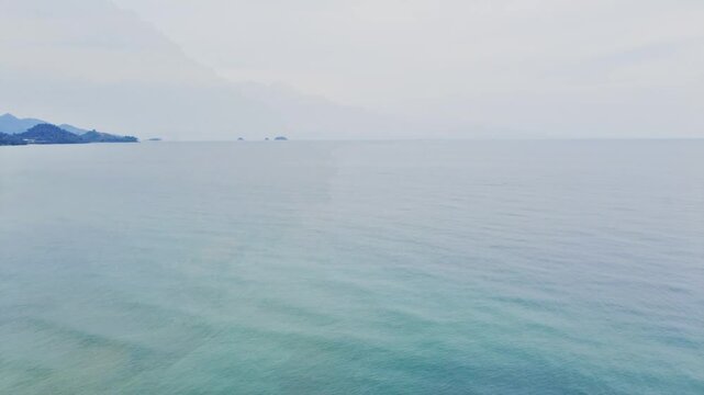 Drone view of amazing white sand beach blending with turquoise waters, palm trees