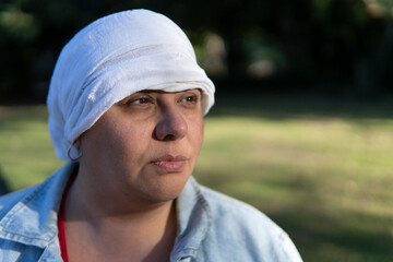 Resilient woman with thoughtful expression in outdoor setting