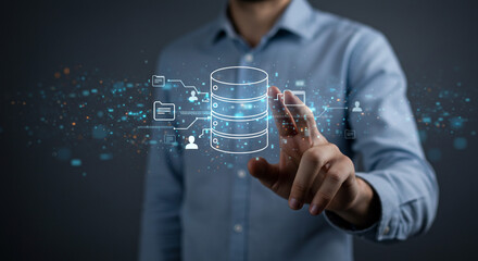 Man in blue shirt interacts with digital database interface with floating icons and connections