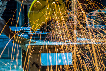 Sparks cutting a metal pipe