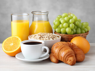Breakfast spread with fresh fruits, coffee, and pastries on a wooden table in a bright kitchen setting